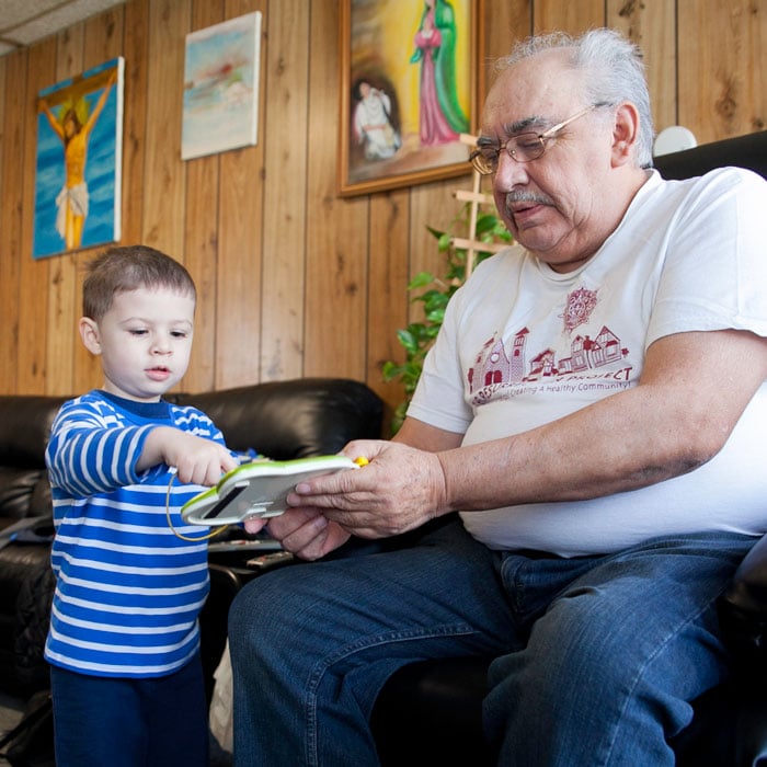 Hernandez plays with his youngest grandson.