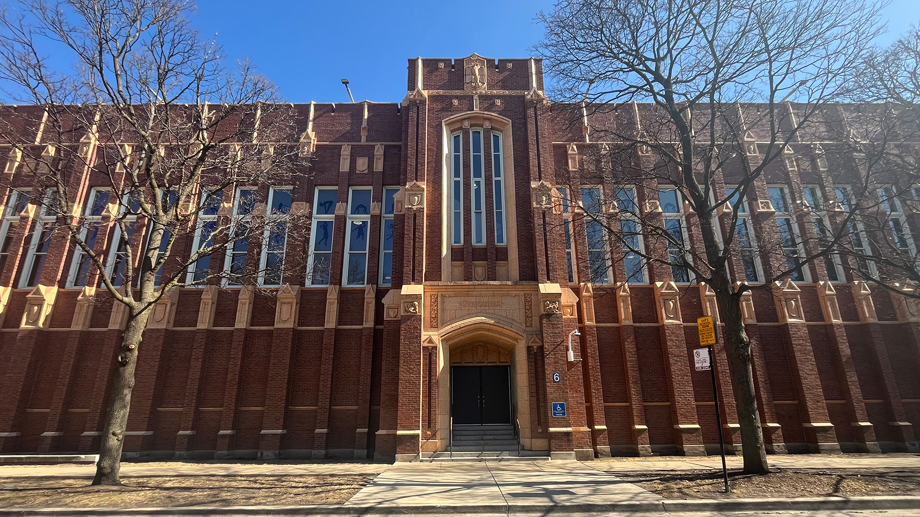 One facade of Roosevelt High School against a blue sky
