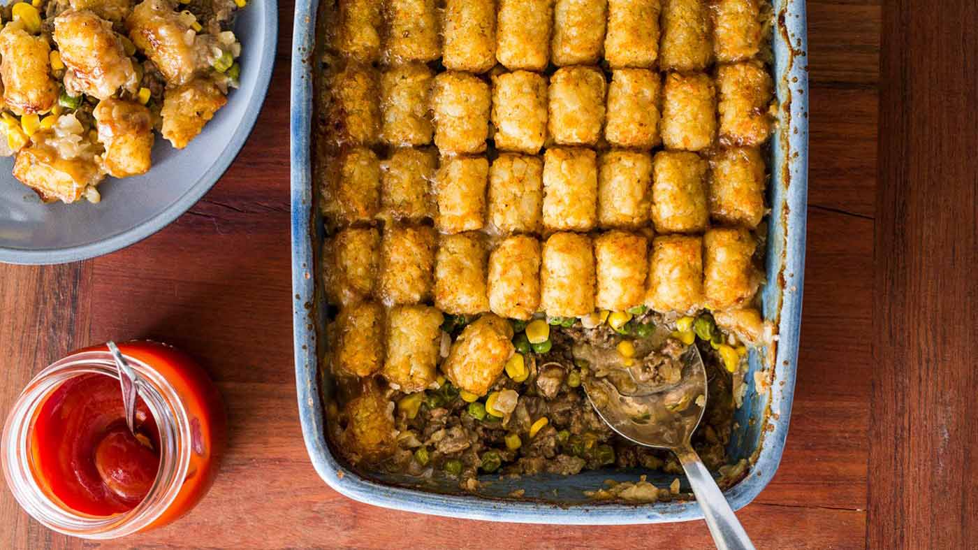 Tater Tot Hotdish in a blue casserole dish 