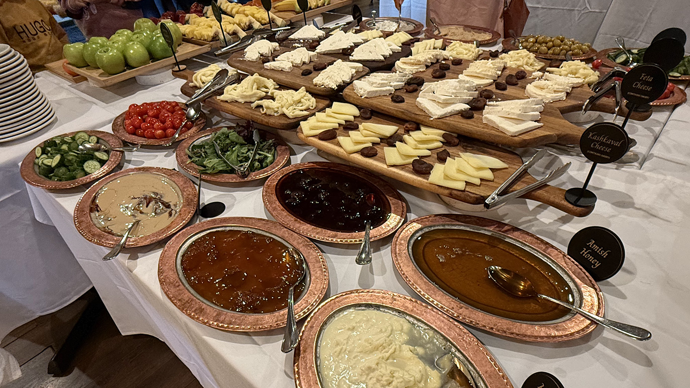 A spread of cheeses, vegetables and more on a table