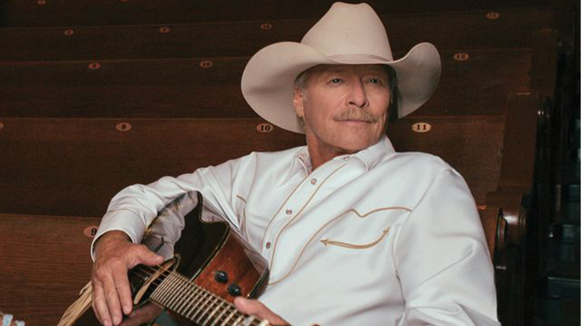 Alan Jackson in a cowboy hat with a guitar