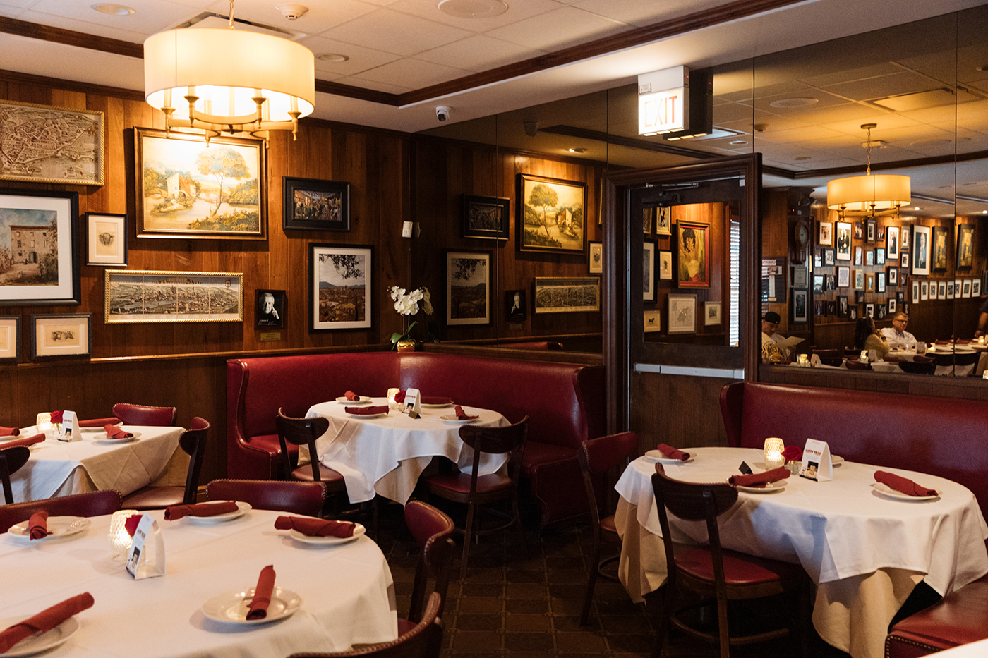 The interior of Gene & Georgetti, with white tablecloths and a corner booth