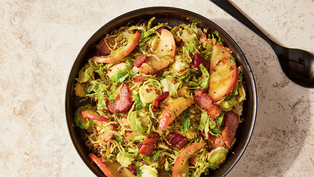 Brussel sprouts with apples and bacon in a round bowl