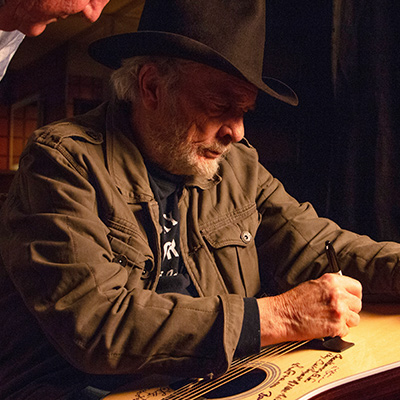 Merle Haggard signs a Martin D-28 guitar. Photo: Courtesy of Jared Ames