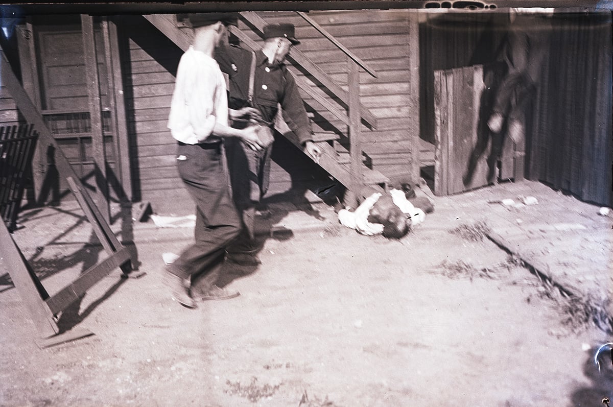 White men stoning black victim during race riots