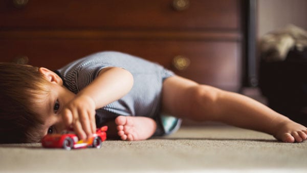 Little boy playing with toy car alone. Little boy playing with toy car alone.