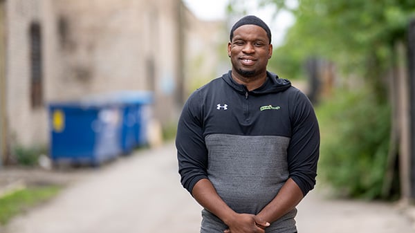 Damien Morris is one of the subjects of WTTW's 'Firsthand: Peacekeepers.' Credit: Abel Arciniega for WTTW A man stands in an alley for a portrait