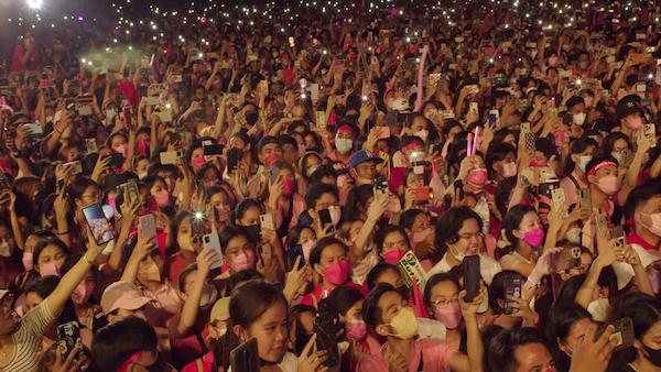 There’s an intersection between “politics and show business” in the Philippines, says the filmmaker Ramona S. Diaz, and “every politician has a kind of spectacle.” Credit: This is How It Ends LLC A crowd of people, many in pink, hold up cell phones at night