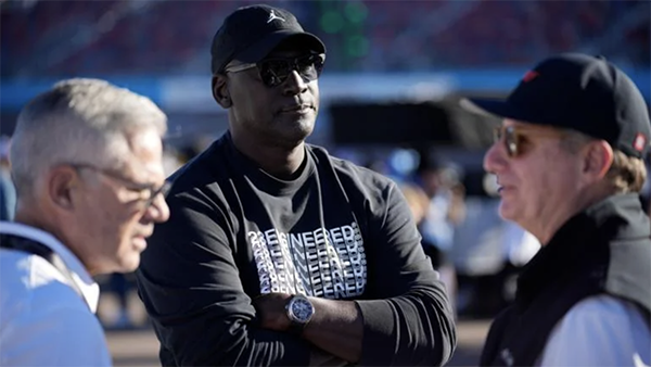 Michael Jordan, center, and Curtis Polk, left, co-owners of 23XI Racing, watch during qualifying beside 23XI Racing President Steve Lauletta, right, for a NASCAR Cup Series Championship auto race, Nov. 9, 2024, in Avondale, Ariz. (AP Photo / John Locher, file) Michael Jordan, center, and Curtis Polk, left, co-owners of 23XI Racing, watch during qualifying beside 23XI Racing President Steve Lauletta, right, for a NASCAR Cup Series Championship auto race, Nov. 9, 2024, in Avondale, Ariz. (AP Photo / John Locher, file)