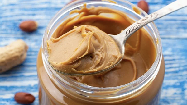 (Sanny11 / iStock) A spoon in a jar of peanut butter