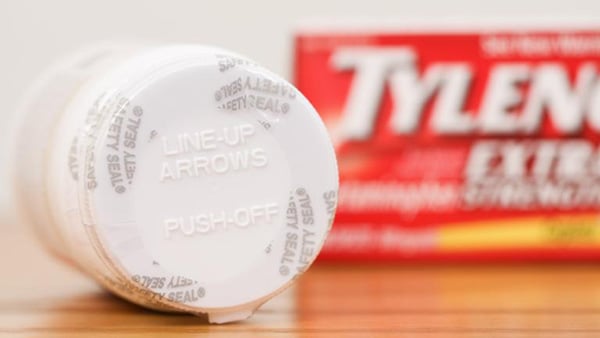 A stock image of a Tylenol bottle turned on its side, with the cardboard packaging in the background