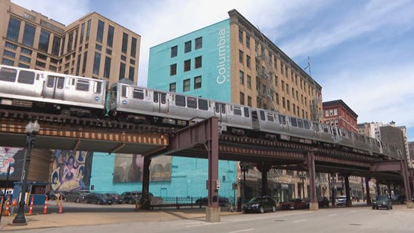 Credit: WTTW News An elevated L train going through downtown Chicago