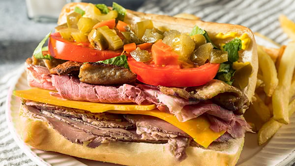 A Jim Shoe (or gym shoe) sandwich is loaded with several kinds of meats and condiments – and it was born here in Chicago. Credit: iStock A sandwich piled high with meat and toppings