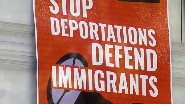 Credit: WTTW News A sign reading "Stop Deportations. Defend Immigrants."