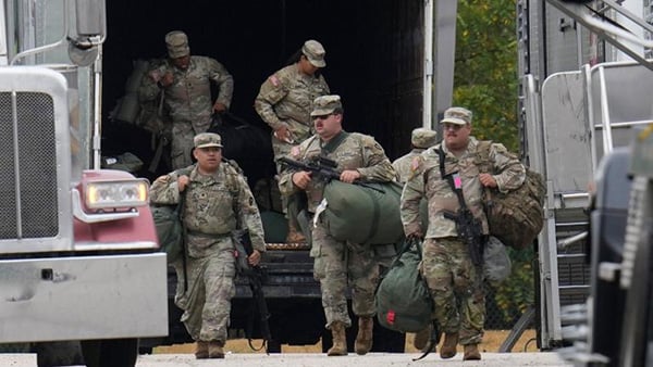 Military personnel in uniform, with the Texas National Guard patch on, are seen at the U.S. Army Reserve Center, Tuesday, Oct. 7, 2025, in Elwood, Ill., a suburb of Chicago. (AP Photo / Erin Hooley)