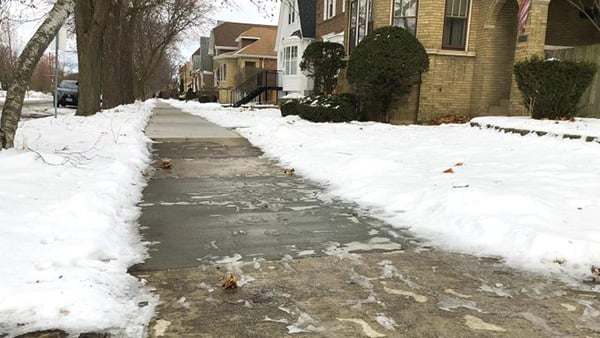 Credit: Patty Wetli / WTTW News A partially cleared sidewalk in Chicago with snow on either side