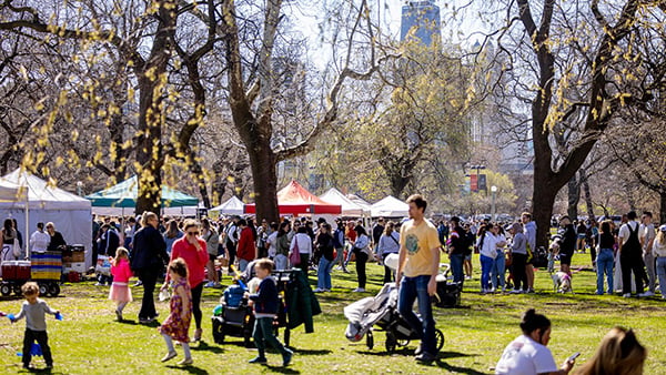 Crowds of people on a lawn during a farmers market