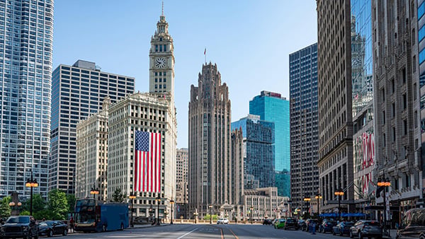 Chicago's skyline and the Wrigley Building with a large American flag hanging on it