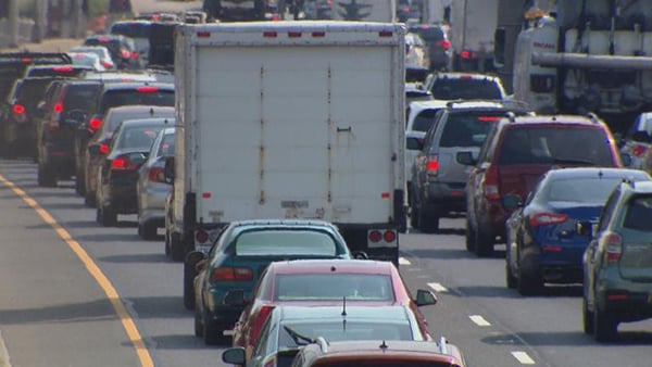 Cars and trucks are pictured on a highway in a stock image