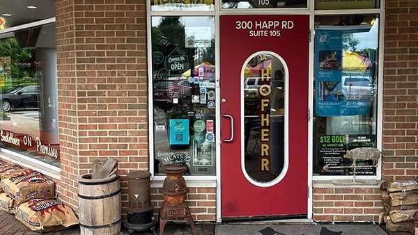 The exterior of Hofherr Meat Co. with its red door