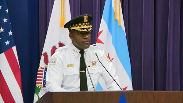 Larry Snelling stands at a podium for a press conference