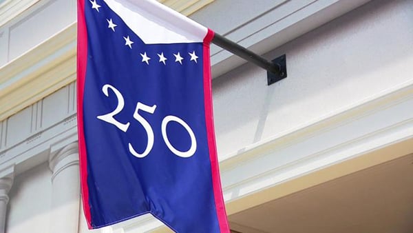A blue banner with red trim and white stars that says 250 on it.