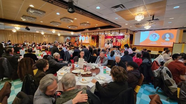 People gather in a ballroom for the Vietnamese Association of Illinois Lunar New Year celebration in 2024.