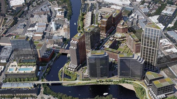 An aerial rending of the proposed Foundry Park development which includes mid- and high-rise buildings along a bend in the North Branch of the Chicago River 