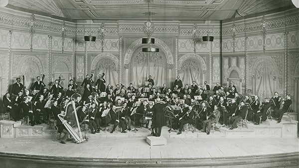 A black and white photo of an orchestra on a stage