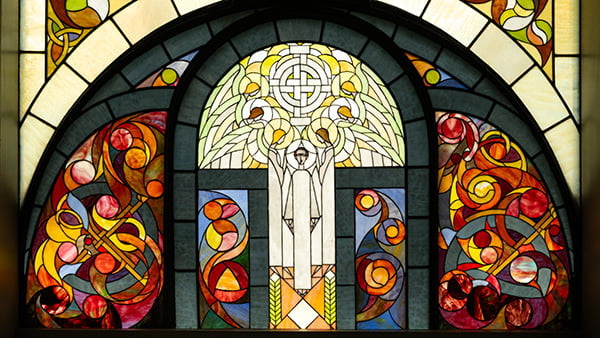 A stained glass window that includes a depiction of angels