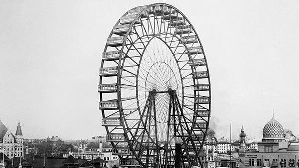 A black and white photo of a ferris wheel