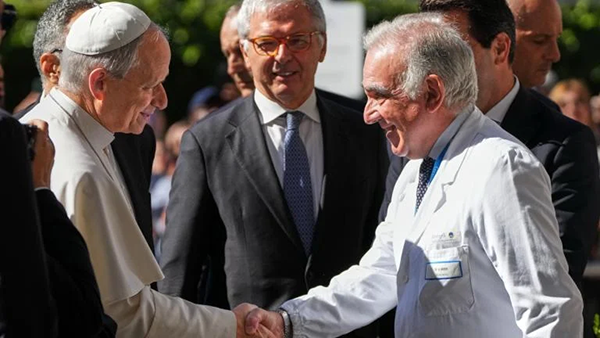 Medical Director Andrea Cambieri, right, greets Pope Leo XIV as he arrives at the Agostino Gemelli Polyclinic in Rome on Tuesday, Oct. 13, 2026, where doctors expect to operate to remove a lung nodule. 