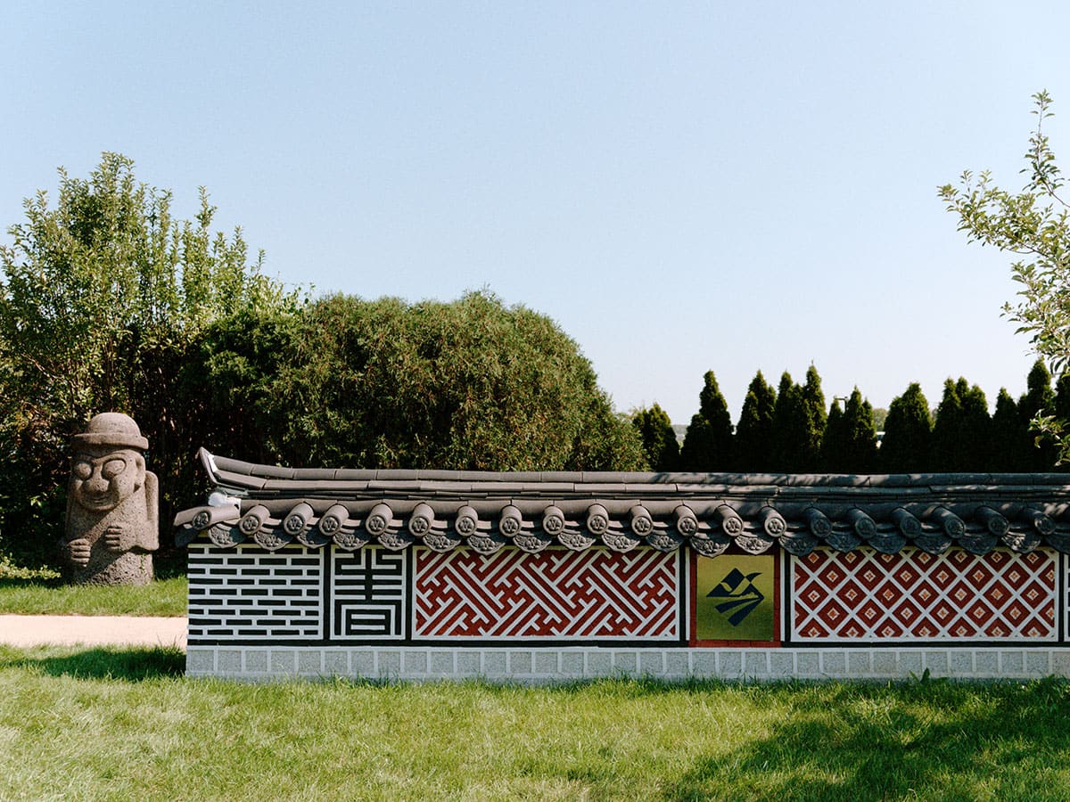 An outdoor scene with a decorated wall