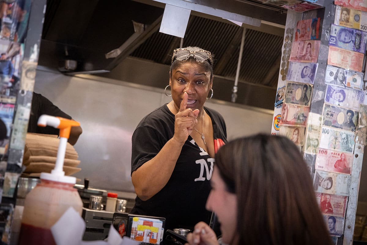 Evelyn Morris raises a finger while talking out of the ordering window at customers