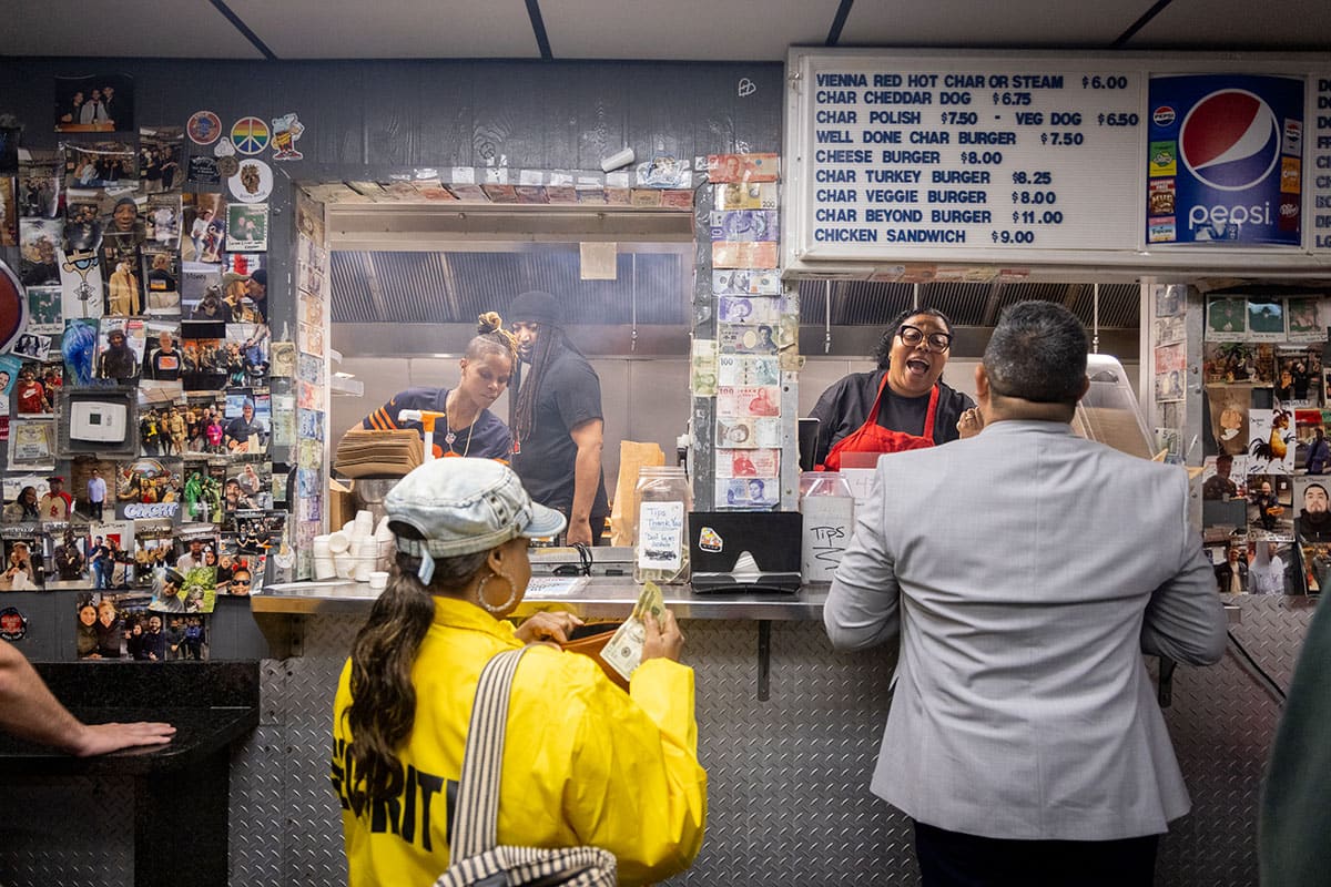 The inside of the Weiner's Circle showing workers behind the counter and customers ordering