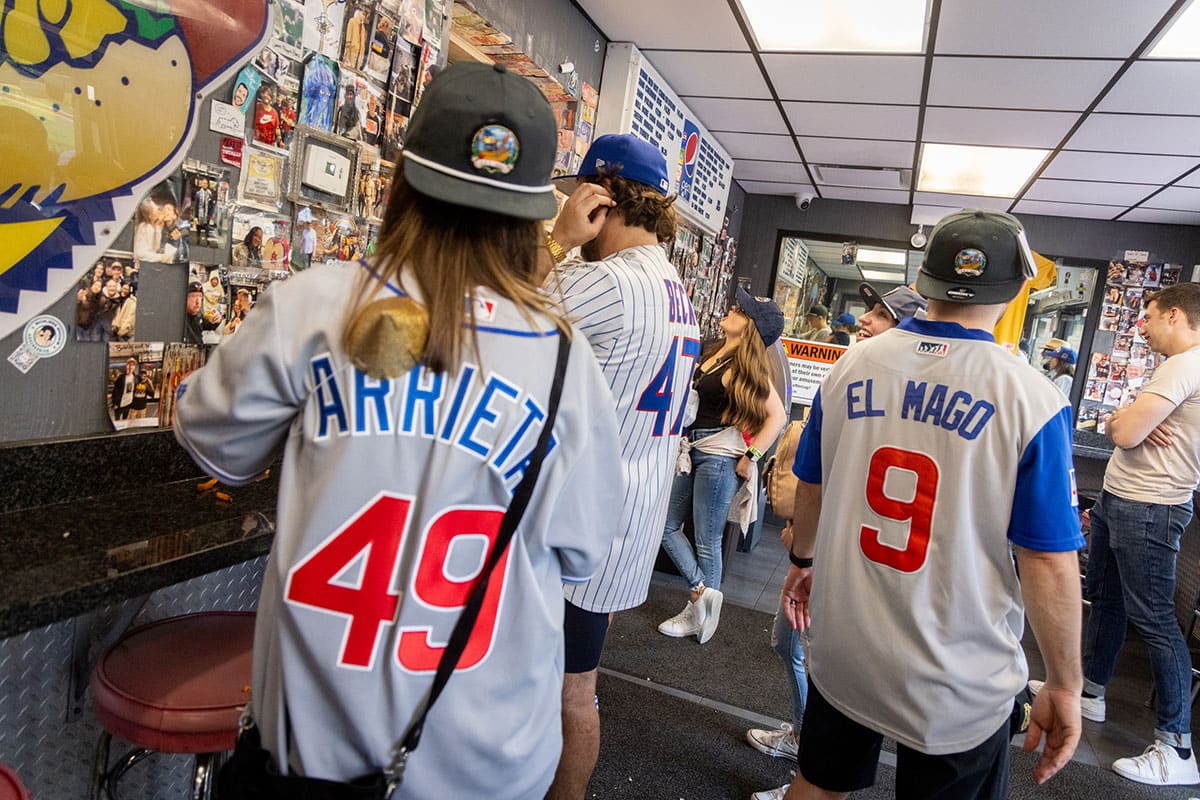 Customers wearing Cubs jerseys waiting for their orders