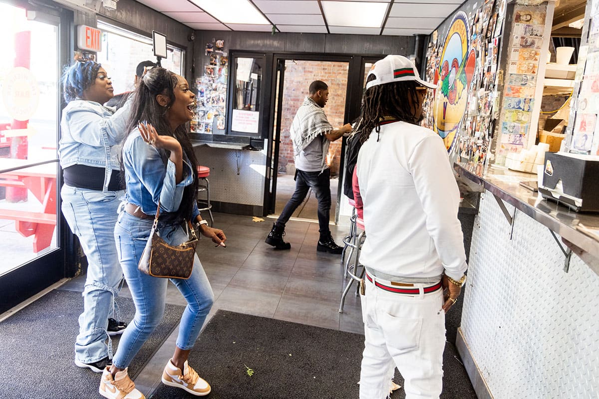Customers stand in line to order, laughing and taking pictures