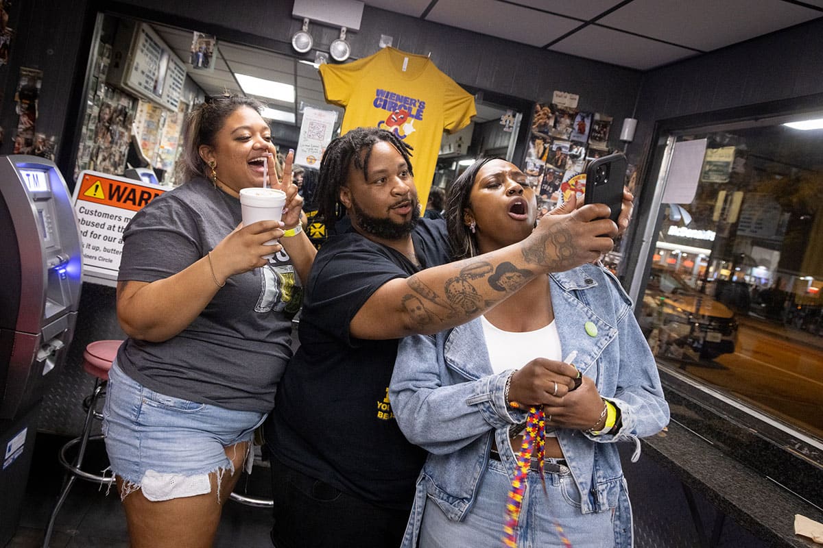 New friends pose for a selfie inside the Weiner's Circle