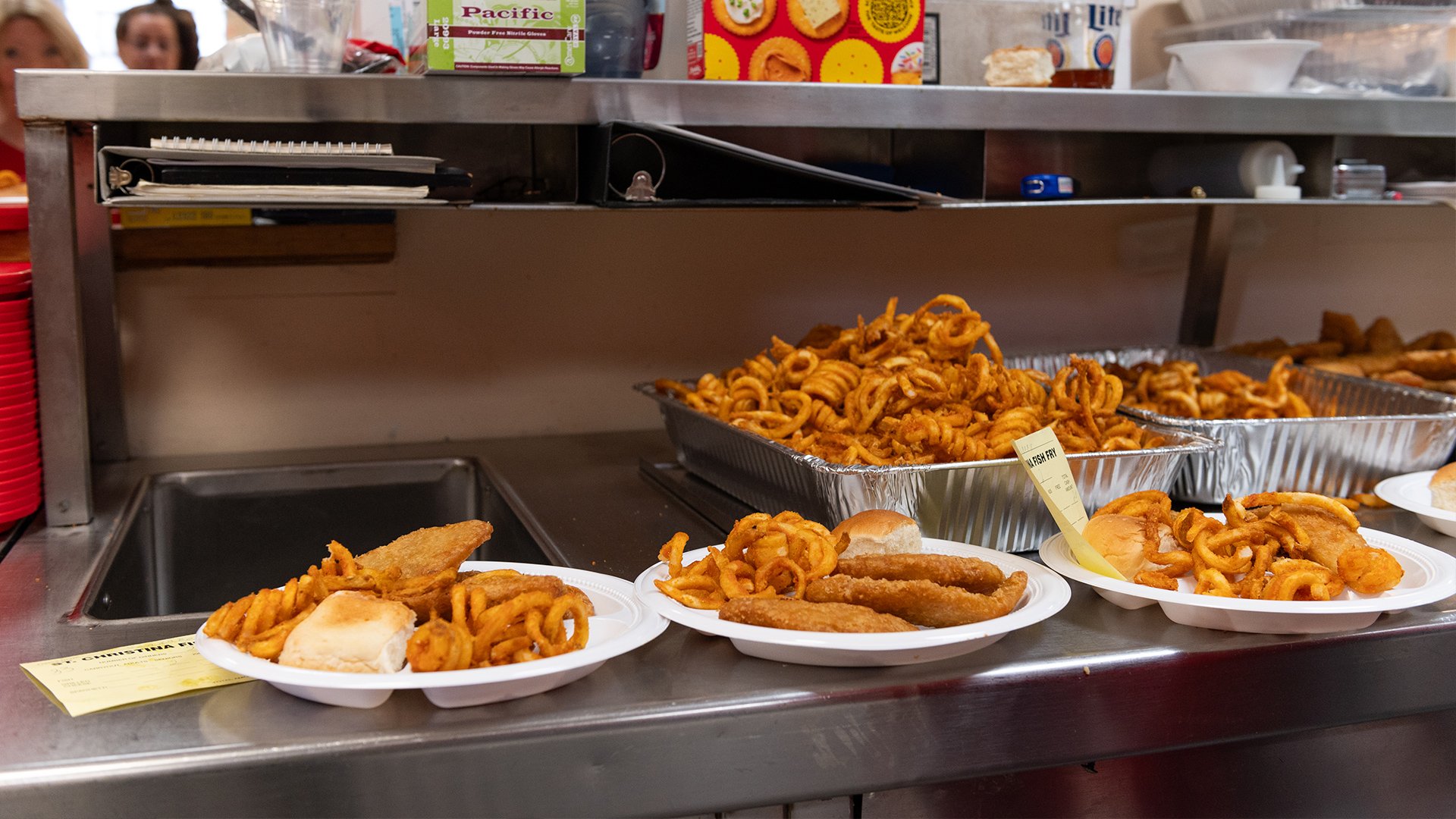 Three plates with fish fries and curly fries