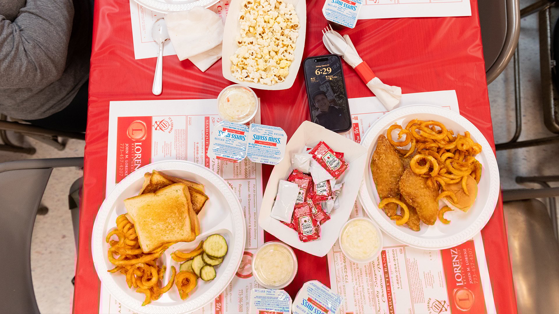 Two plates of fish fries with curly fries