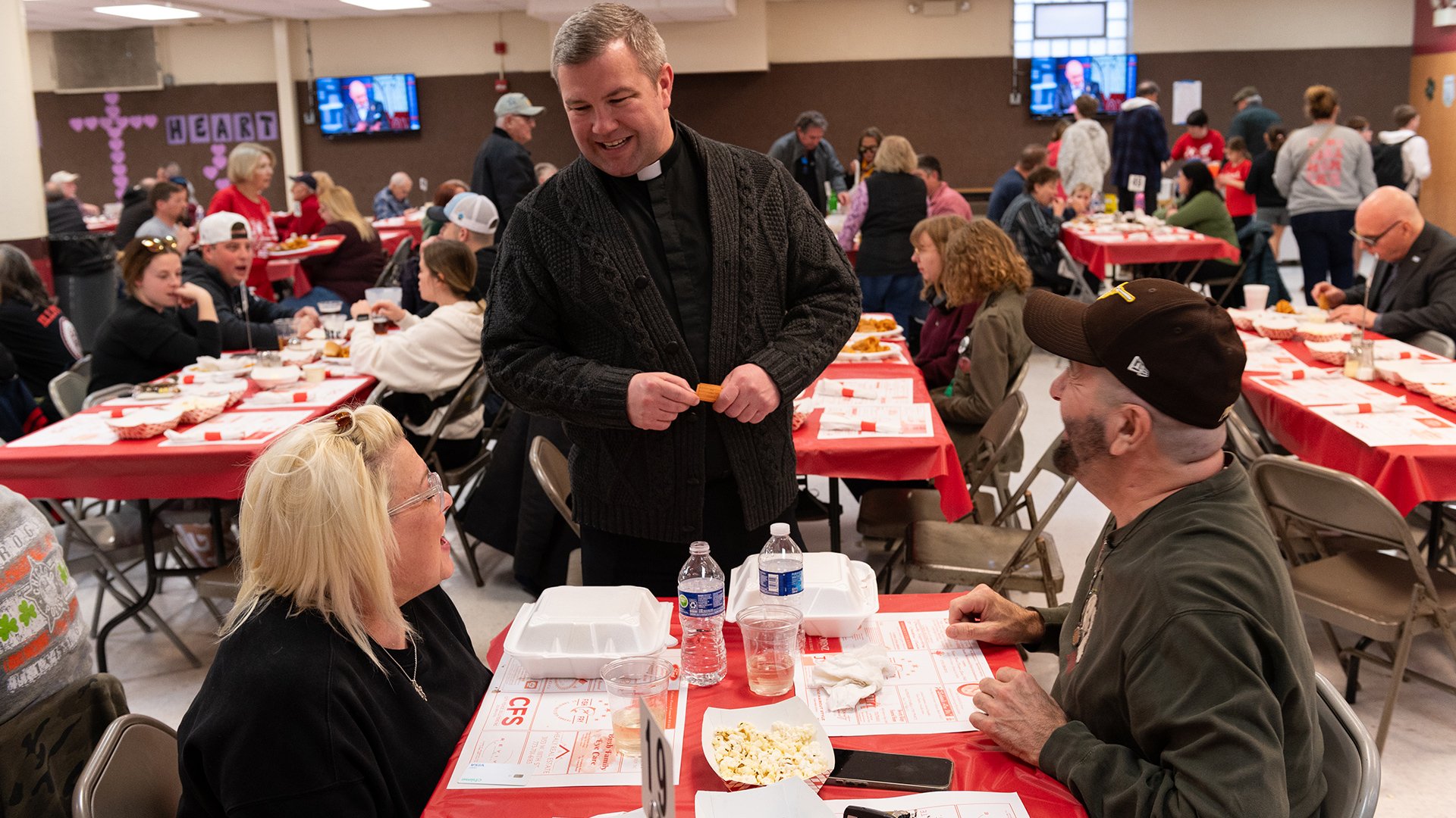The pastor visiting a table of guests