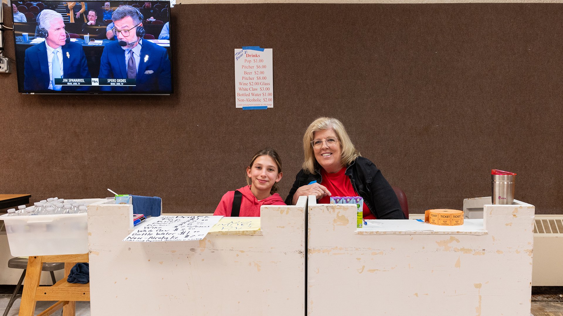 A child sitting with a woman at a booth