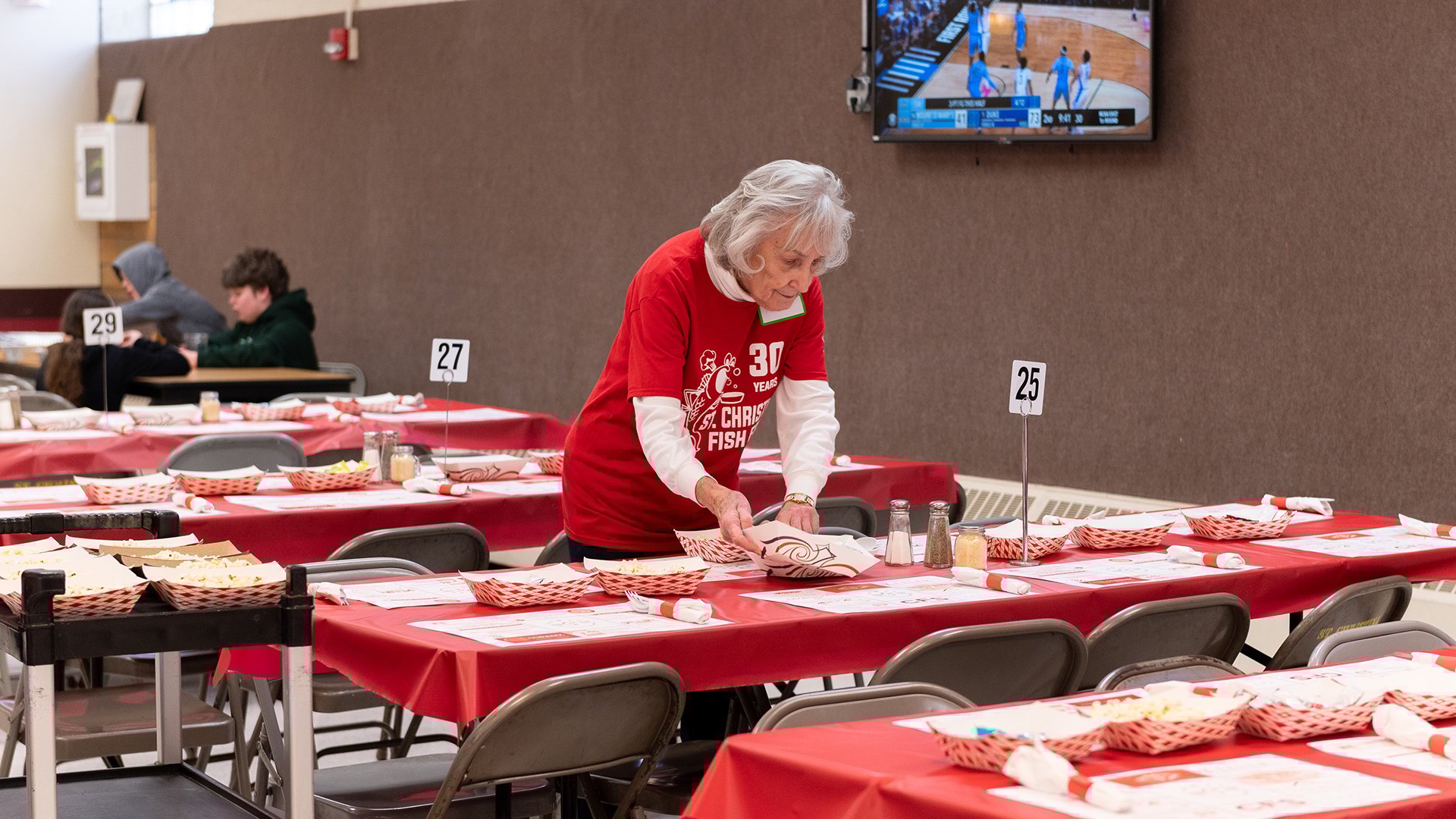 A St. Christina's volunteer setting a table