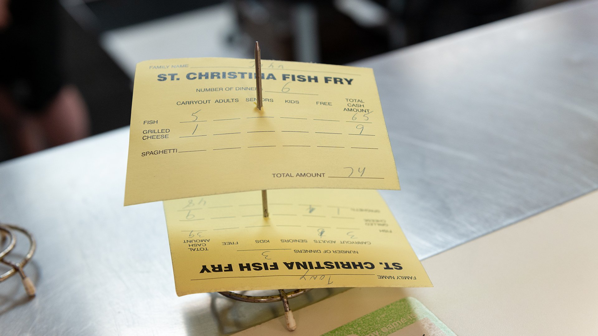 Two order cards skewered on a wooden spike