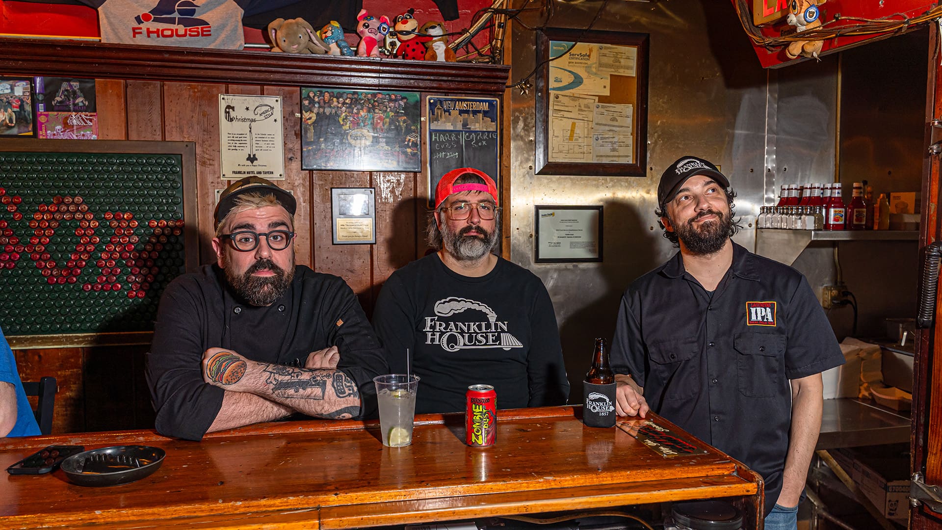 Three bearded men sit at the Franklin House bar