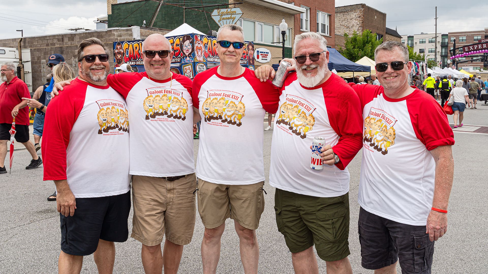 Five men wearing matching t-shirts pose for their photo