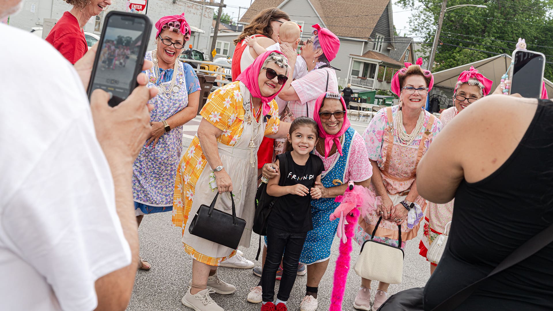 A young girl poses with the 'buscias' as others take photos on their cell phones