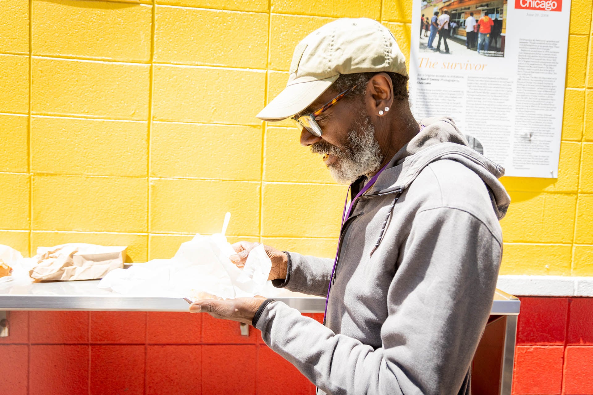 A customer eating at the outdoor counter of Jim’s Original
