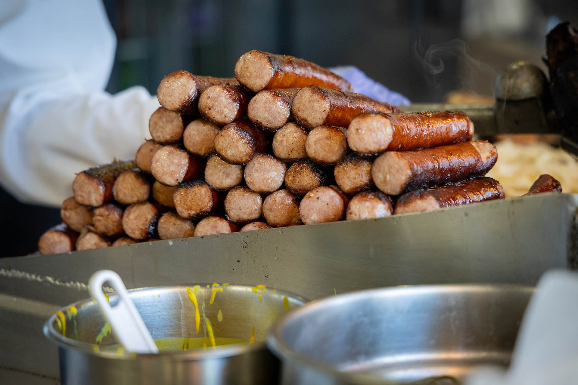 A pile of Polish sausages on the grill at Jim’s Original