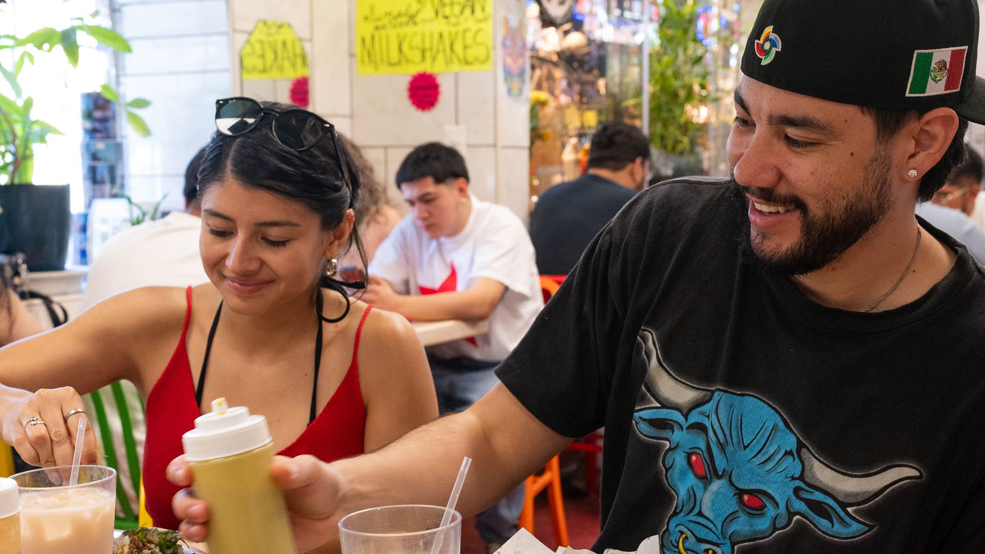 Two people smile as they sit at a table